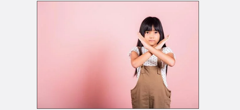 Child doing sign to stop