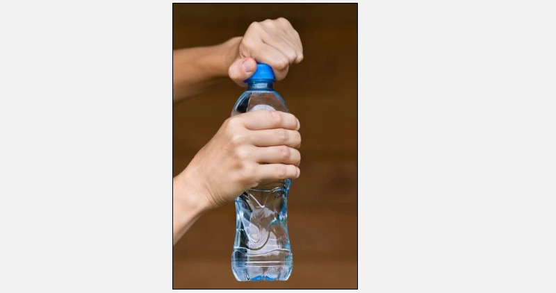 Hands opening a water bottle